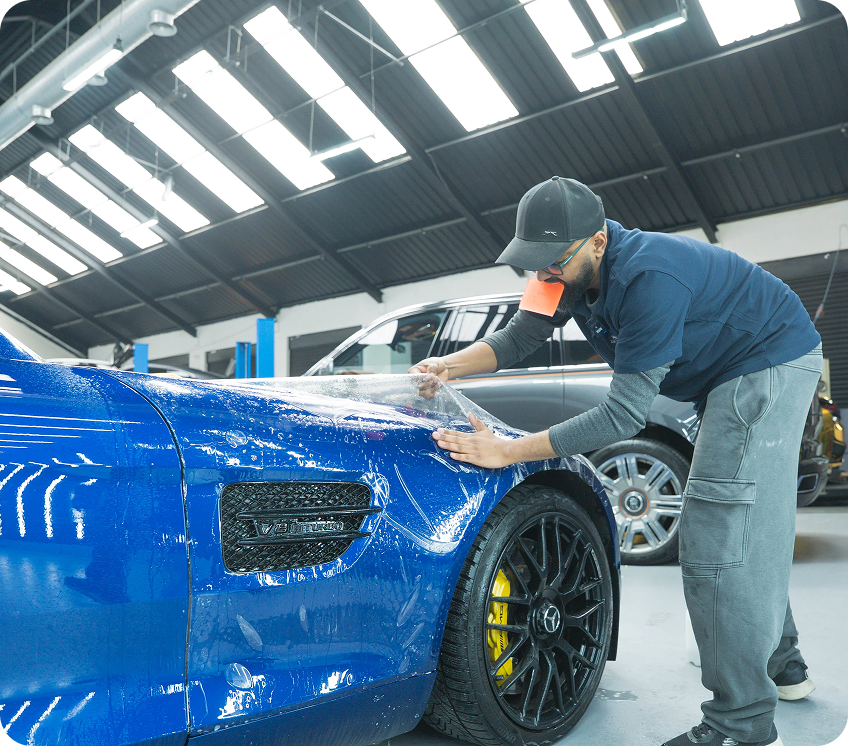 Applying paint protection film to car panel to prevent stone chips and scratches